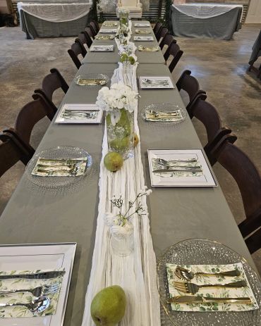 Elegant long dining table set for a formal meal.