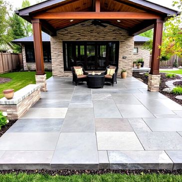 Modern covered patio with stone flooring and cozy seating area.