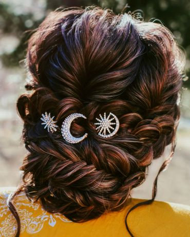 Intricate braided hairstyle with celestial hairpins.
