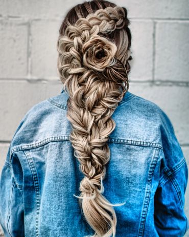 Intricate braided hairstyle with floral detail.