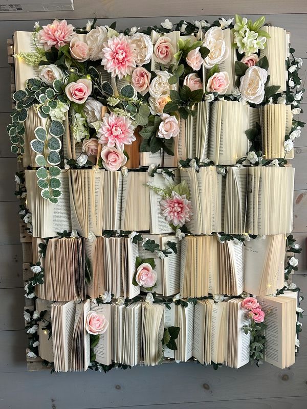 Books and flowers artfully arranged on a table.