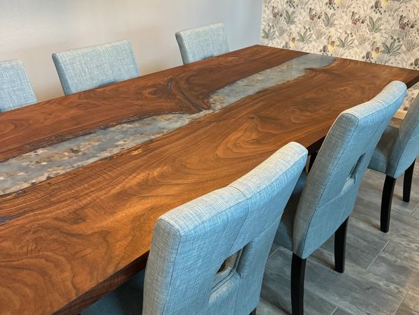 Custom dining table with waterfall end and river scene, hand crafted from claro walnut wood and epox