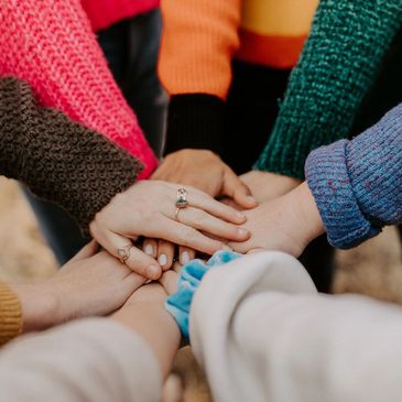 Hands stacked together in unity.