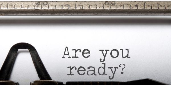 This is a typewriter with the words, "Are you ready?", typed on a sheet of white paper.