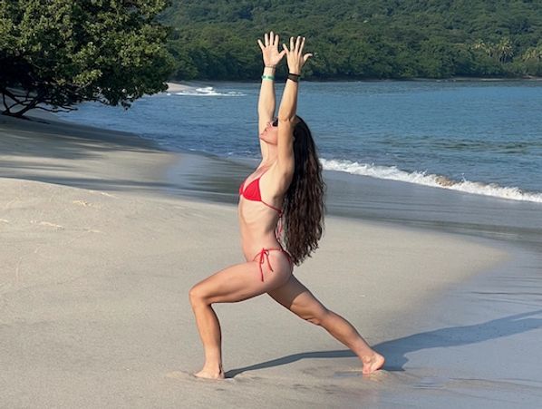 Doing yoga on the beach in Costa Rica at a yoga retreat