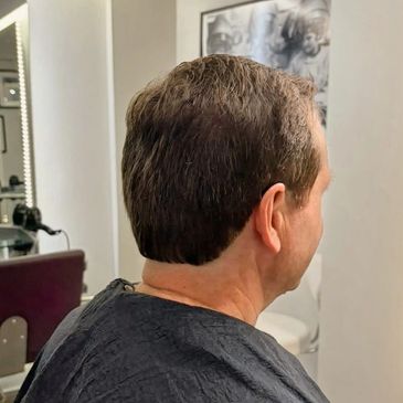 Men’s haircut showing a neat, textured style at Castell Hair Salon in Holt.