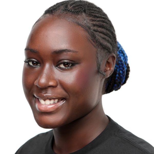 Smiling woman with braided hair and blue highlights.