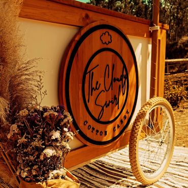 Big, wooden logo of The Cloudy Swirl 