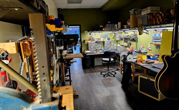 "Guitar repair Shop with tools and a vintage guitars."