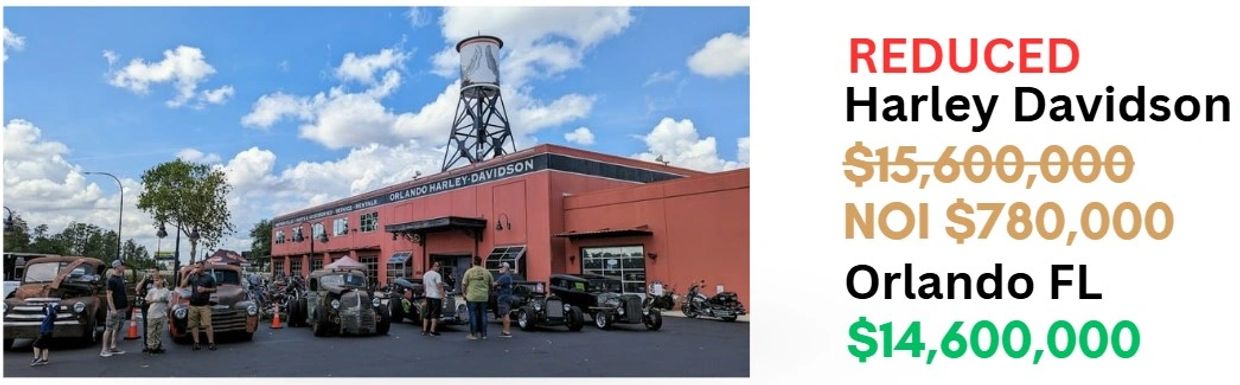 Harley Davidson dealership in Orlando with classic cars and a price reduction sign.