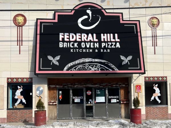 Facade of Federal Hill Brick Oven Pizza kitchen and bar with pizza-themed art.