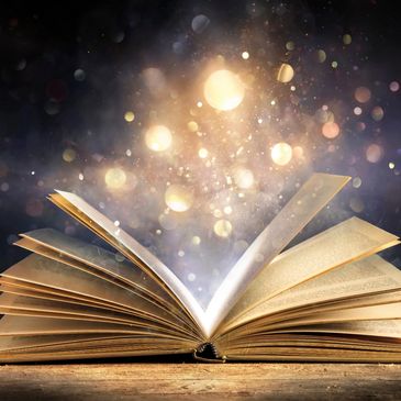An open book with glowing magical lights emanating from its pages.