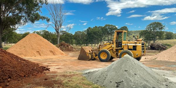 Front Loader with landscape/quarry supplies such as foil fill, granite sand, crusher dust and sand.