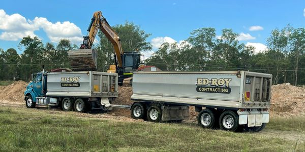 Tipper Truck and Dog being loaded with fill by Excavator