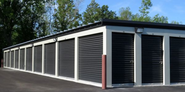 Row of closed storage unit doors in a self-storage facility.