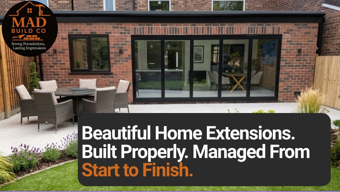 Modern home extension with patio furniture and large glass doors.