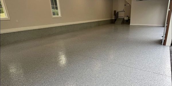 Clean, speckled epoxy garage floor with smooth finish.