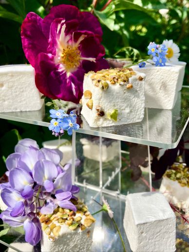 Marshmallow treats on cake stand with flowers