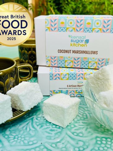 Coconut marshmallows on a plate in front of a coconut marshmallows box with Gold Award sticker