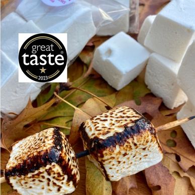 vanilla marshmallows in packs and toasted on a skewer