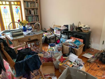 Before photo of a cluttered dining area.