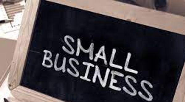 Chalkboard sign with 'SMALL BUSINESS' written on it.