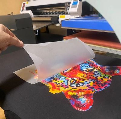 A vibrant multicolored leopard print on black fabric being revealed.