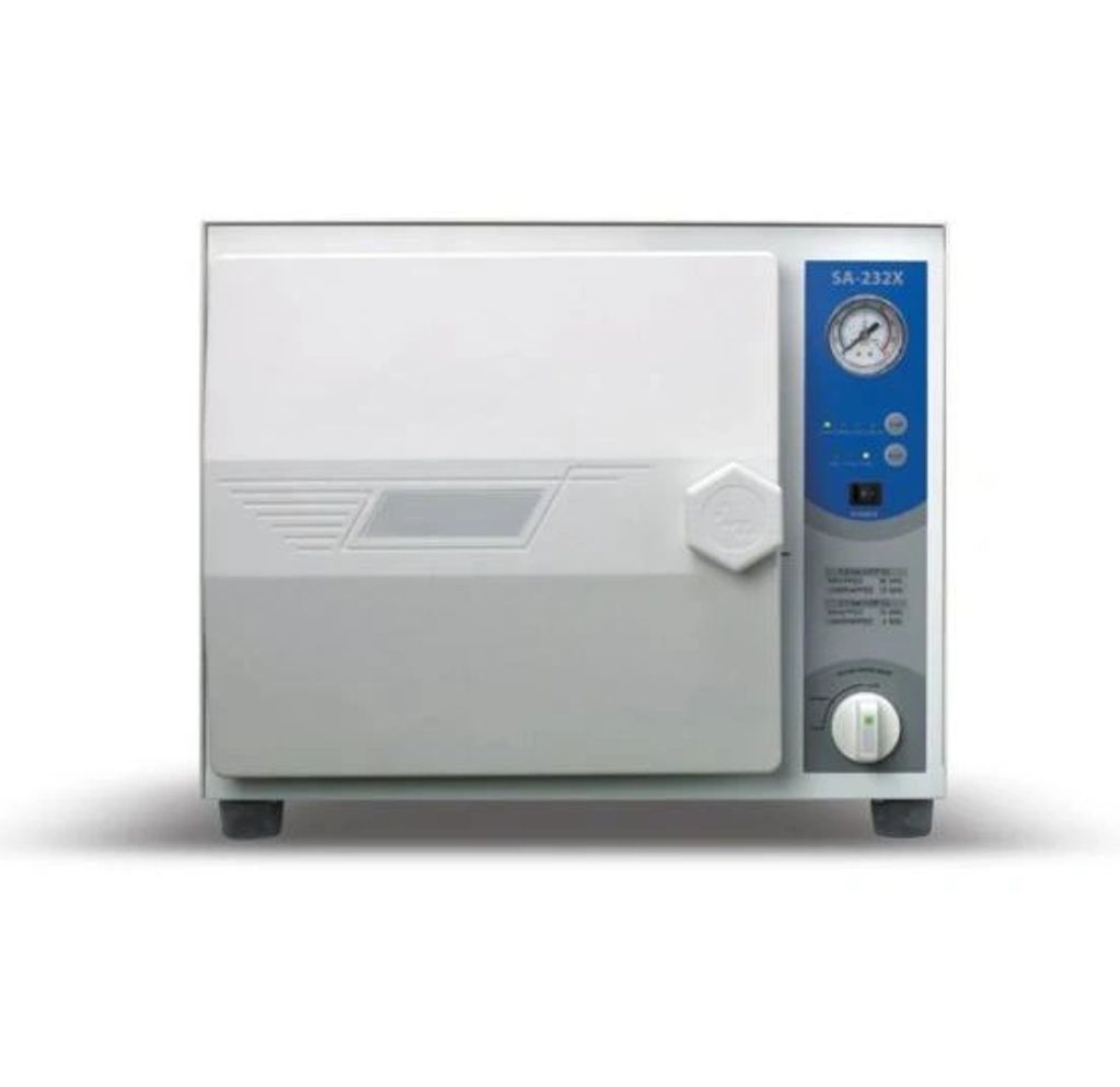 A white laboratory autoclave sterilizer with a pressure gauge and control panel.