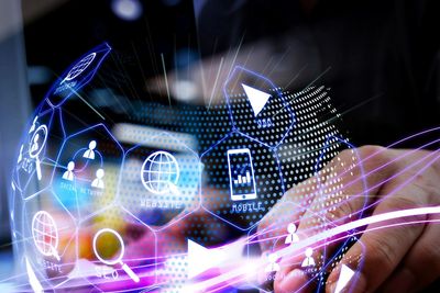 Hand interacting with a digital technology interface representing a technology holding company