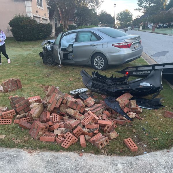 Wrecked vehicle that took down a brick mailbox.