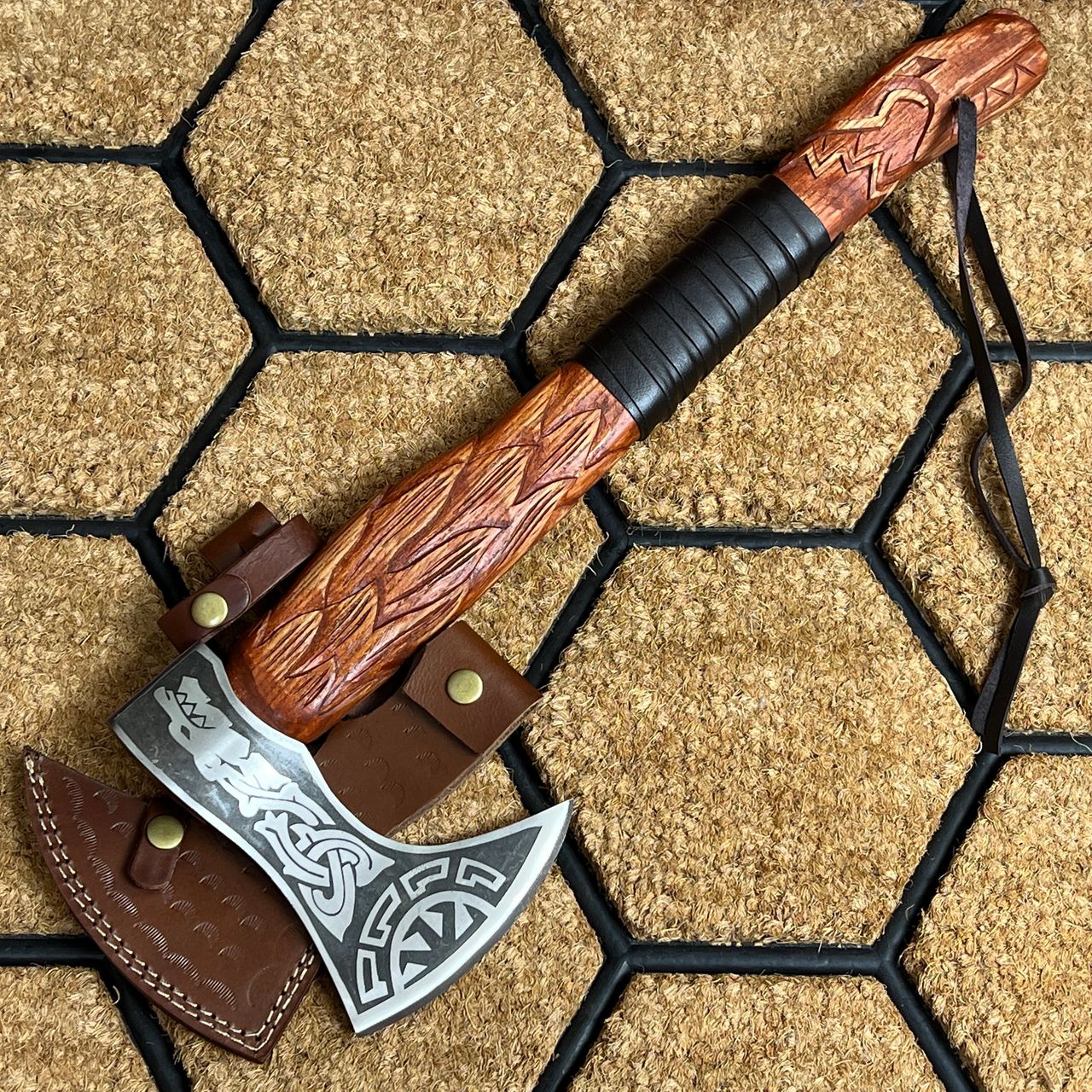 A Viking axe, featuring a sturdy wooden handle and a sharp, bearded iron head. The axehead is intricately designed with Norse-inspired patterns, and the overall weapon exudes a robust and functional aesthetic. The handle is adorned with leather wrappings for a secure grip, and the entire axe reflects the craftsmanship and utilitarian elegance characteristic of Viking weaponry.