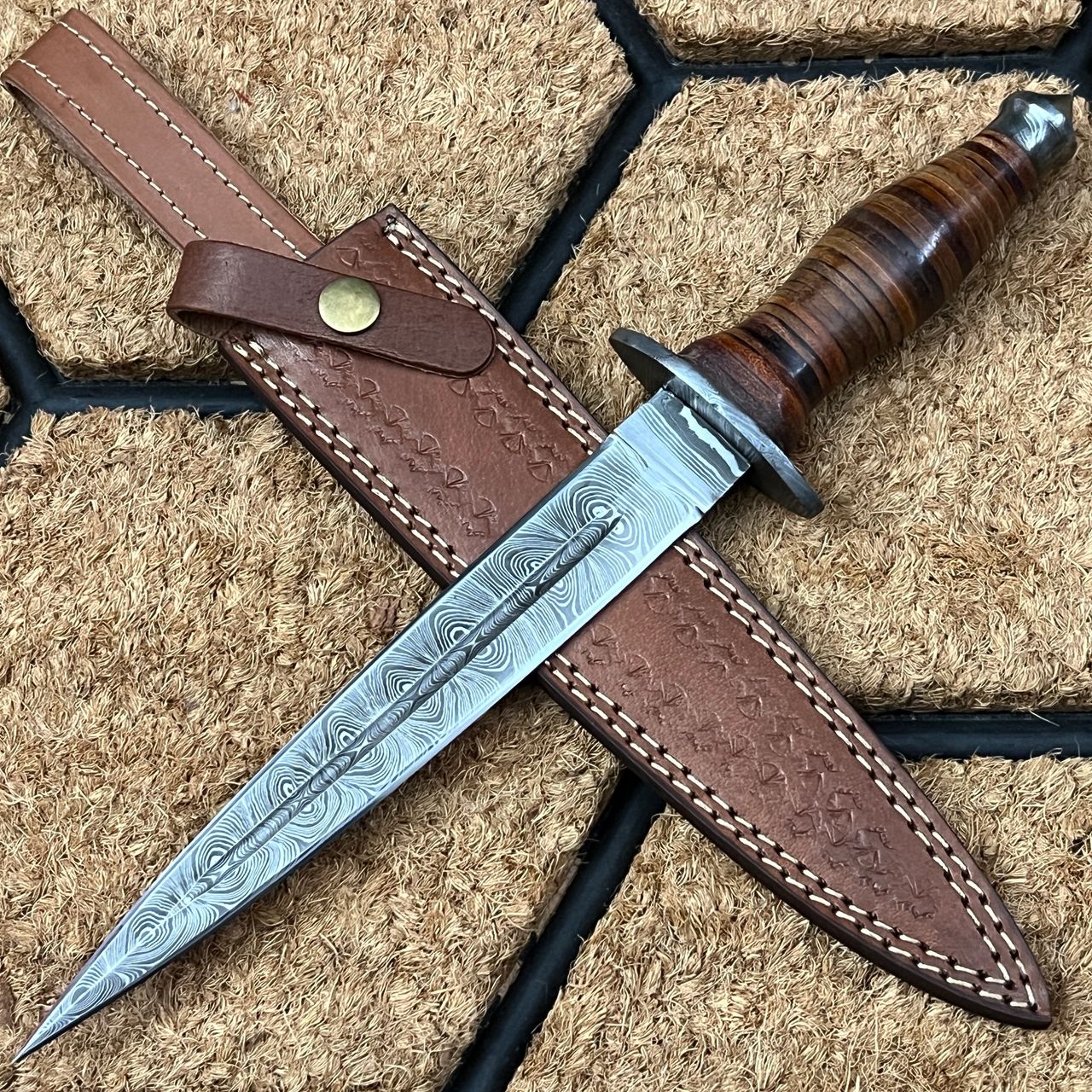 The blade of this Hunting Dagger knife is finished with a damascus steel, making it both durable and sharp. Damascus steel guard with stack leather was used for the grip. The kit includes a sheath for storage and transport. The Hunting knife is lightweight, sturdy, and long-lasting.  The ideal fixed blade knife for all outdoor and survival activities.  Utility blade for tactical use. Includes a Cowhide leather with a belt loop for storage and protection. Ideal equipment for outdoorsmen, hikers, hunters. You may clip your hunting knife to your belt with the help of this sturdy and functional holder.