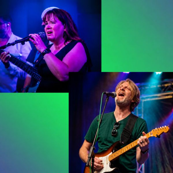 Two singers passionately performing on stage with instruments.