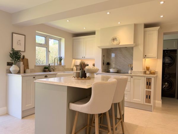 Bright modern kitchen with beige tones and marble countertops.