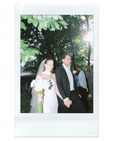 Bride and groom holding hands outdoors on their wedding day.