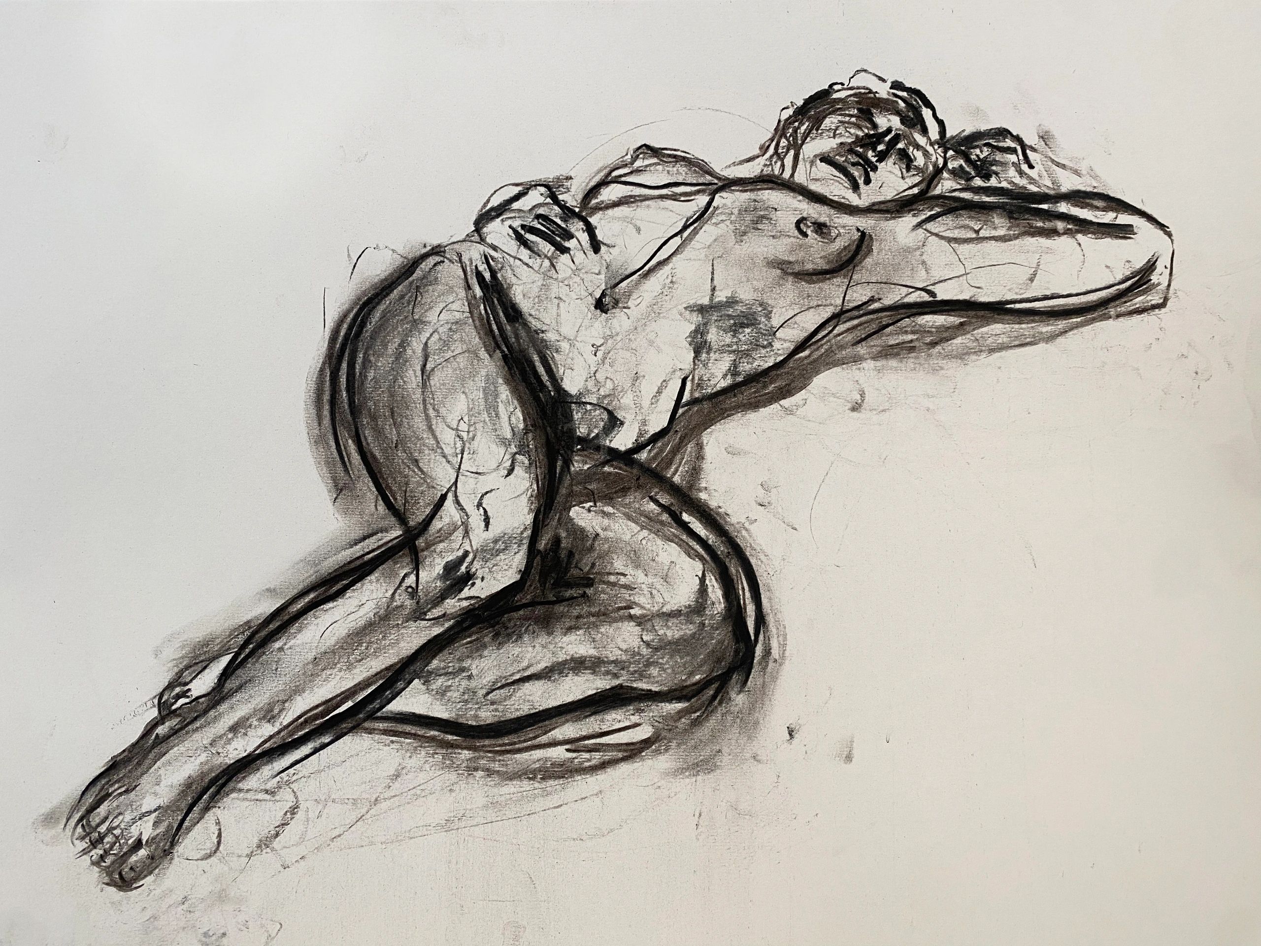 Charcoal sketch of a reclining nude figure with expressive lines.