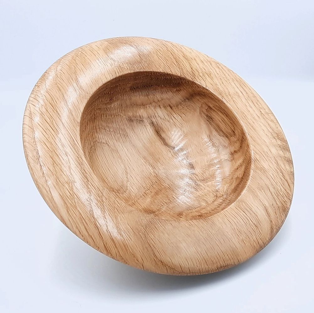Wide-rimmed bowl turned from English Oak, standing semi-upright.