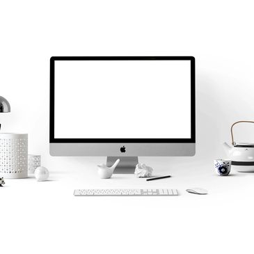 Minimalist workspace with an Apple iMac and white accessories.