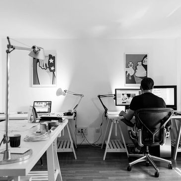 Person working at a desk with computers in a modern office.