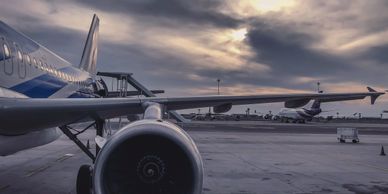 Jet engine mounted under the wing of a commercial airliner.