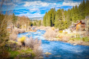 A winding mountain river with mountains in background.