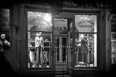An elegant window display of vintage attire.