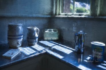 Morning sunlight spills onto a counter from the window above.  In this 1940s kitchen a percolator gu