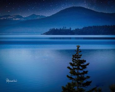 Night view of Lake Tahoe under starlit sky.