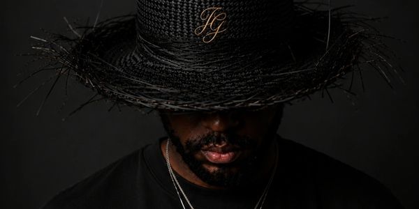 Man in a black hat with initials FG.