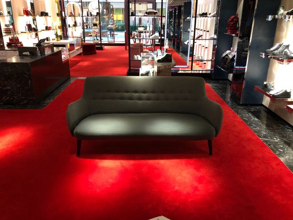 Gray sofa located in the Christian Louboutin Houston Galleria after fabric upholstery cleaning.
