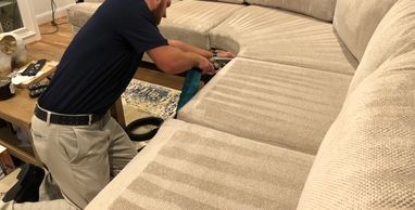 In progress cleaning of a sectional by a fabric cleaning technician. 