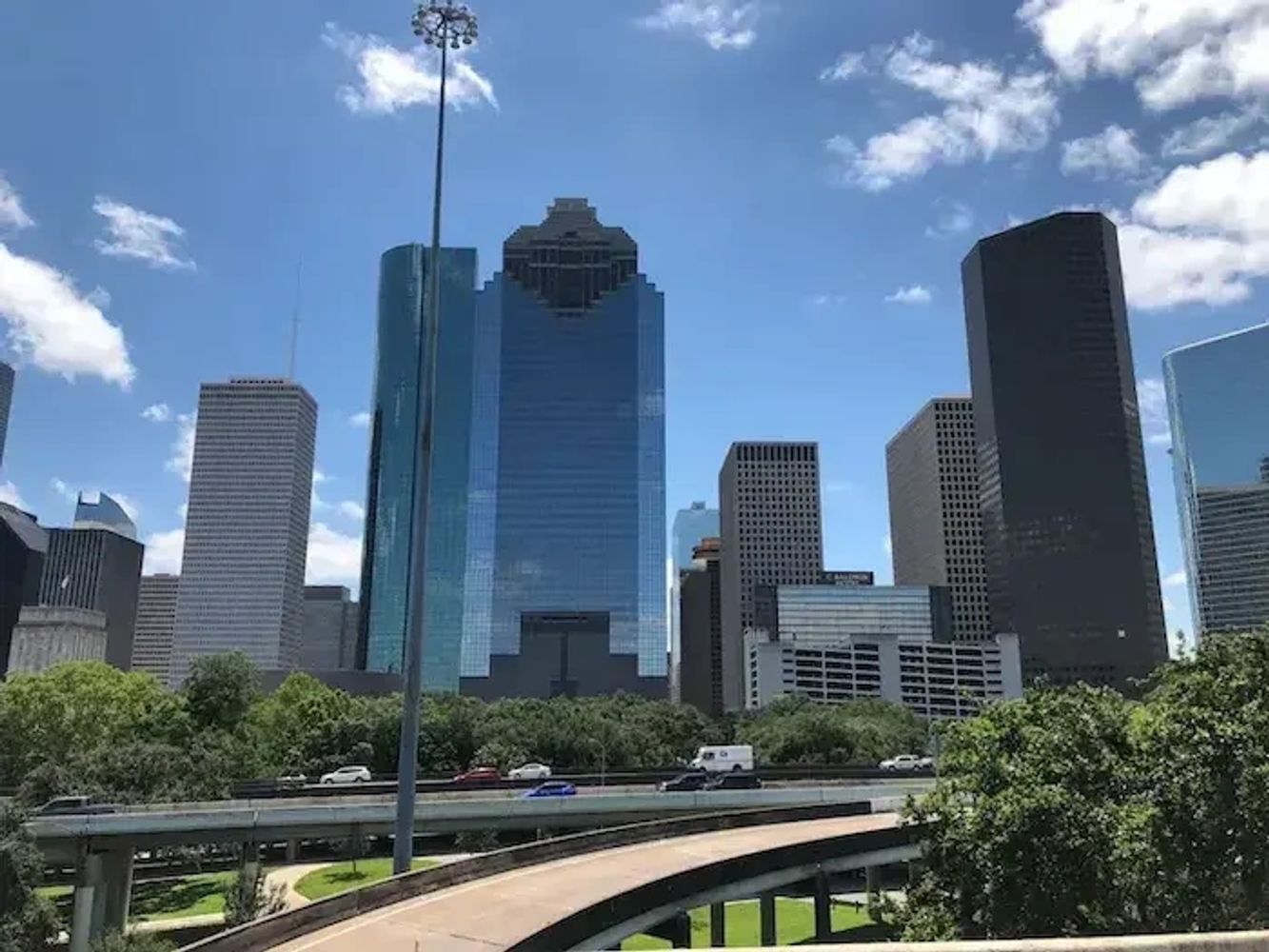 Upholstery cleaning near me by the downtown Houston skyline on a beautiful day.