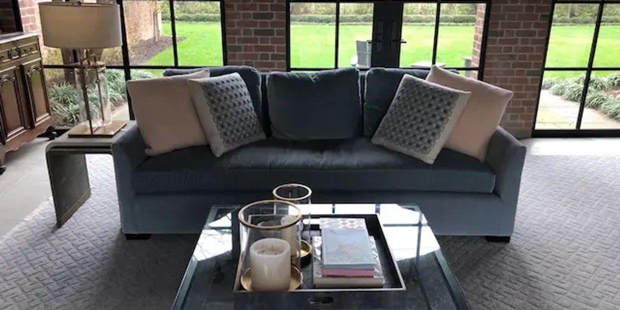 Luxurious blue velvet sofa in living room after professional dry solvent cleaning.