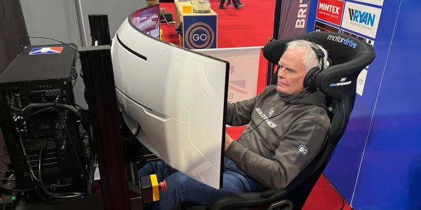 Older man using a racing simulator setup.